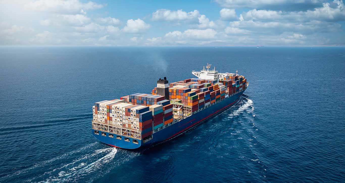 Large container cargo ship loaded with containers at sea.