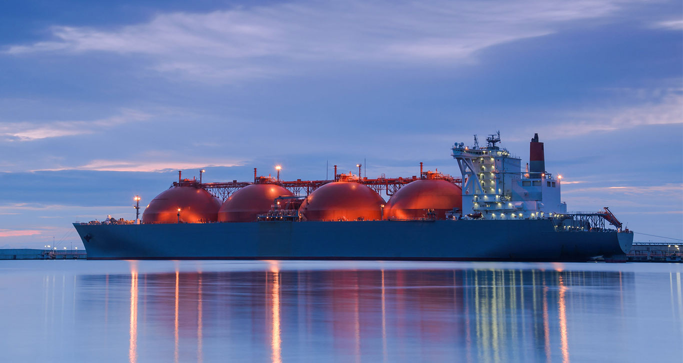 Large LNG (liquid natural gas) tanker at sea at twilight.